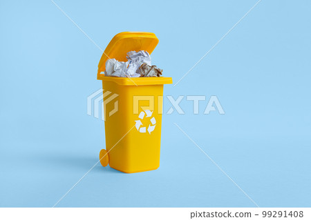 Almost closed container with paper waste isolated on the blue background with copy space, waste recycling concept Almost closed container with paper waste isolated on the blue background with copy space, waste recycling concept 99291408