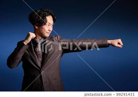 Young business person taking a fighting pose Young business person taking a fighting pose 99291431