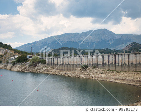 A large concrete bridge across the lake 99293178