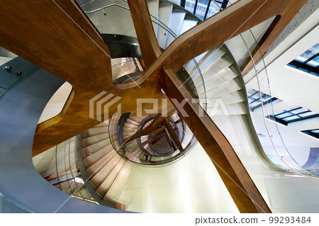 Spiral staircase seen from above and with artificial lighting. 99293484