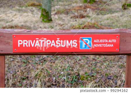 A red warning sign that does not allow parking. Inscriptions in Latvian 99294162