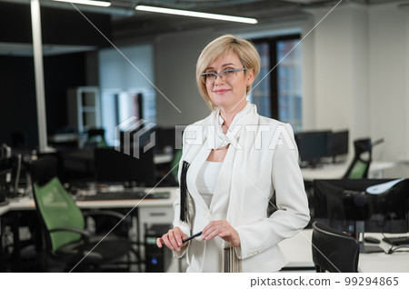 Portrait caucasian business woman shows holding a pen in the office. 99294865