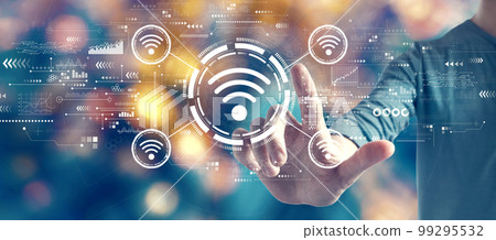 Wifi theme with man on blurred city light background Wifi theme with man on blurred city light background 99295532