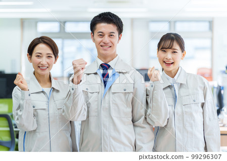 A worker doing a guts pose in the office A worker doing a guts pose in the office 99296307