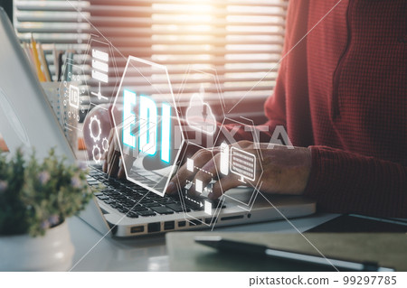 EDI-electronic data interchange concept, Person using computer on office desk with virtual screen EDI icon. EDI-electronic data interchange concept, Person using computer on office desk with virtual screen EDI icon. 99297785