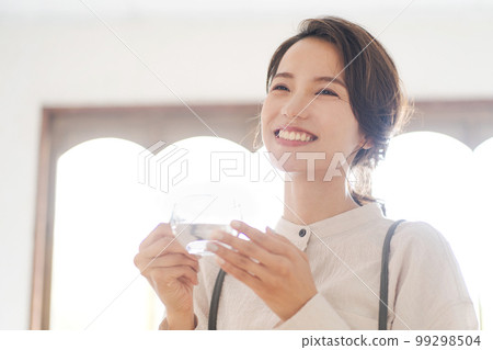 Photo of a woman drinking hot water Photo of a woman drinking hot water 99298504