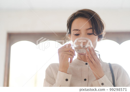 Photo of a woman drinking hot water 99298571