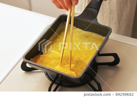 Tamagoyaki being cooked in the kitchen Tamagoyaki being cooked in the kitchen 99299682