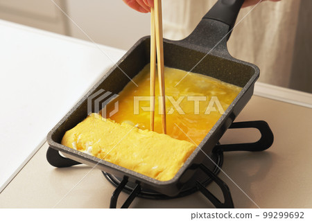 Tamagoyaki being cooked in the kitchen 99299692