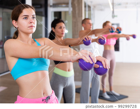 People with dumbbells in hands 99299728