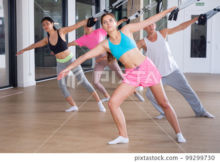People exercising with pilates reformers People exercising with pilates reformers 99299730