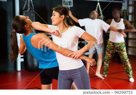 Womens sparring in self defense courses in gym 99299755
