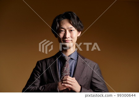 A young business person looking at you with a smile 99300644