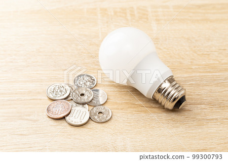 LED bulbs and coins on the table 99300793