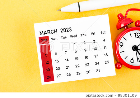 The March 2023 Monthly calendar for 2023 year with alarm clock on yellow background. 99301109
