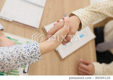 The handshake of business people in the office, close-up 99304120