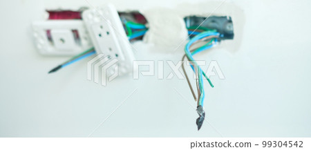 Electrical Wiring under plaster, hidden installation cables for socket to a concrete. Renovation, Repair and development of home and apartment concepts Electrical Wiring under plaster, hidden installation cables for socket to a concrete. Renovation, Repair and development of home and apartment concepts 99304542