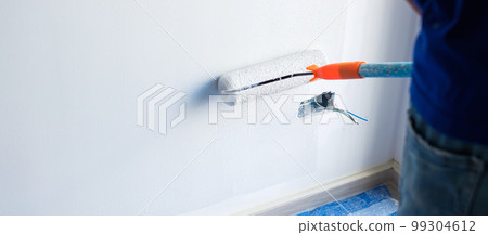 painter man with paint roller brush painting the wall. Renovation, maintenance and development of home or apartment painter man with paint roller brush painting the wall. Renovation, maintenance and development of home or apartment 99304612