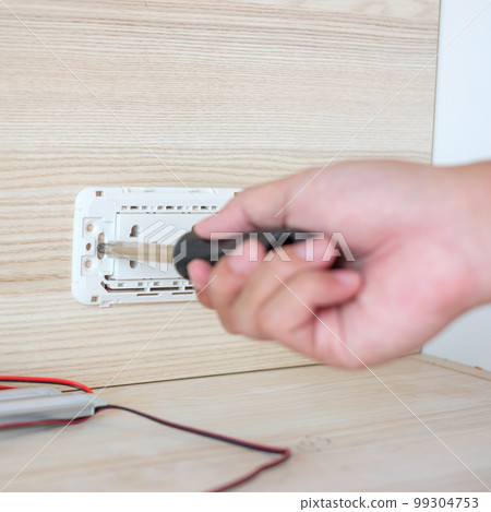Man hand using screwdriver installing Wire cables for socket plug. Renovation, Repair, fixing and development of home and apartment concepts Man hand using screwdriver installing Wire cables for socket plug. Renovation, Repair, fixing and development of home and apartment concepts 99304753