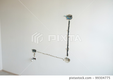 Electrical Wiring under plaster, hidden installation cables for socket to a concrete. Renovation, Repair and development of home and apartment concepts 99304775