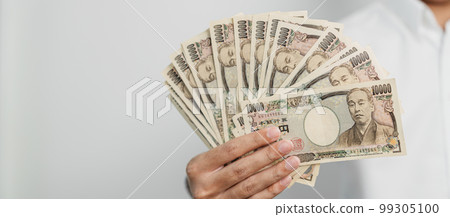 man hand holding Japanese Yen banknote stack. Thousand Yen money. Japan cash, Tax, Recession Economy, Inflation, Investment, finance and shopping payment concepts man hand holding Japanese Yen banknote stack. Thousand Yen money. Japan cash, Tax, Recession Economy, Inflation, Investment, finance and shopping payment concepts 99305100
