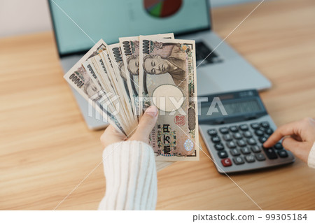 Woman hand counting Japanese Yen banknote with calculator. Thousand Yen money. Japan cash, Tax, Recession Economy, Inflation, Investment, finance, salary and payment concepts Woman hand counting Japanese Yen banknote with calculator. Thousand Yen money. Japan cash, Tax, Recession Economy, Inflation, Investment, finance, salary and payment concepts 99305184