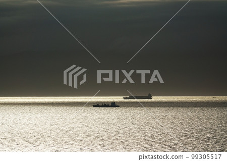 A ship sailing on a sparkling sea reflecting the sun Summer 220727pm 99305517