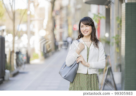 A smiling Arafif woman walking in the city 99305983