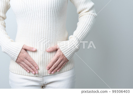 Woman holding  her belly. Pregnancy, Reproductive system, menstruation, and gynecology concept 99306403
