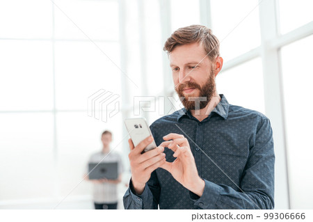 handsome businessman choosing a contact number in his smartphone handsome businessman choosing a contact number in his smartphone 99306666