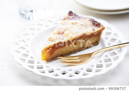 Apple tart and golden fork on bright table Apple tart and golden fork on bright table 99306737