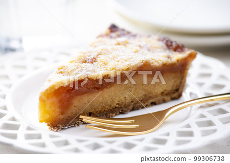 Apple tart and golden fork on bright table Apple tart and golden fork on bright table 99306738