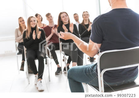 working group applauding the business speaker during the meeting . working group applauding the business speaker during the meeting . 99307223
