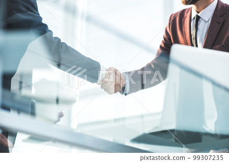 bottom view. handshake of business partners over the Desk 99307235