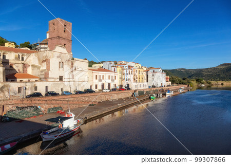 River with Homes and Apartments in Touristic Town. Bosa, Sardinia, Italy. 99307866