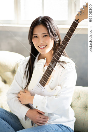 Young woman portrait (electric guitar) 99308300