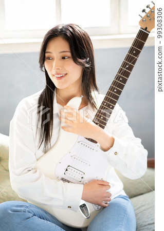 Young woman portrait (electric guitar) 99308306