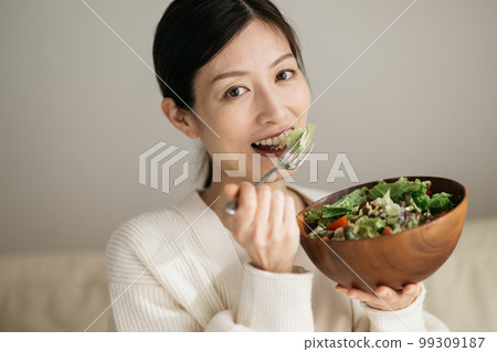Woman eating salad Woman eating salad 99309187