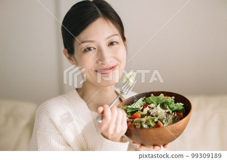 Woman eating salad 99309189