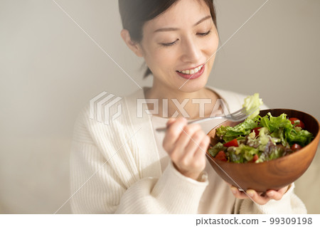 Woman eating salad Woman eating salad 99309198