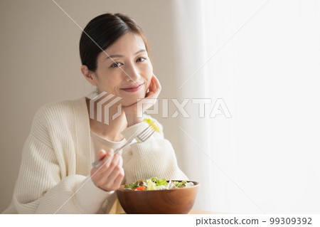 Woman eating salad 99309392