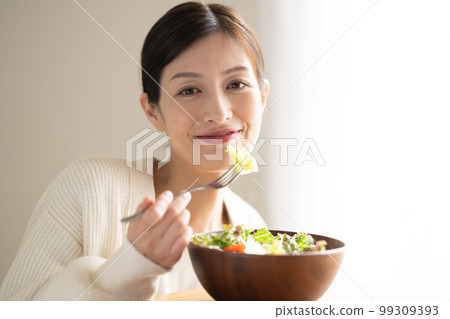 Woman eating salad Woman eating salad 99309393