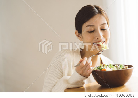 Woman eating salad Woman eating salad 99309395