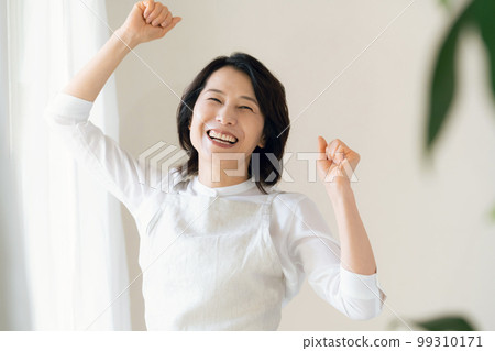 Middle woman doing a guts pose by the window 99310171