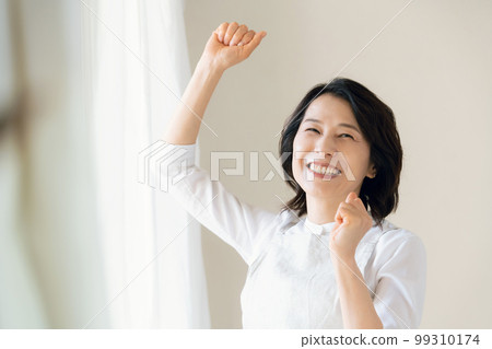 Middle woman doing a guts pose by the window Middle woman doing a guts pose by the window 99310174