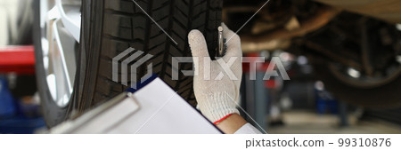 Man mechanic working under car at car service station 99310876