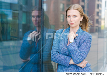 Confident successful smiling business woman entrepreneur in suit standing 99310957