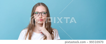Worried stupid and insecure young woman with long hair nervous fingers in alarm Worried stupid and insecure young woman with long hair nervous fingers in alarm 99310970