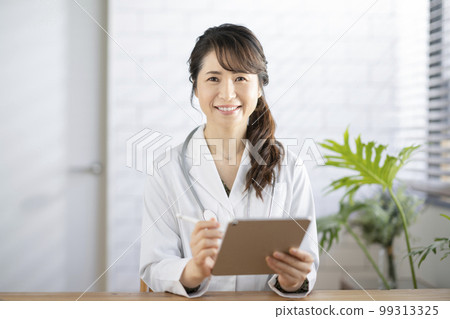 Smiling female doctor looking at camera 99313325