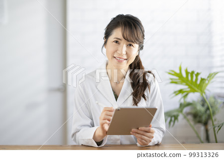 Smiling female doctor looking at camera 99313326